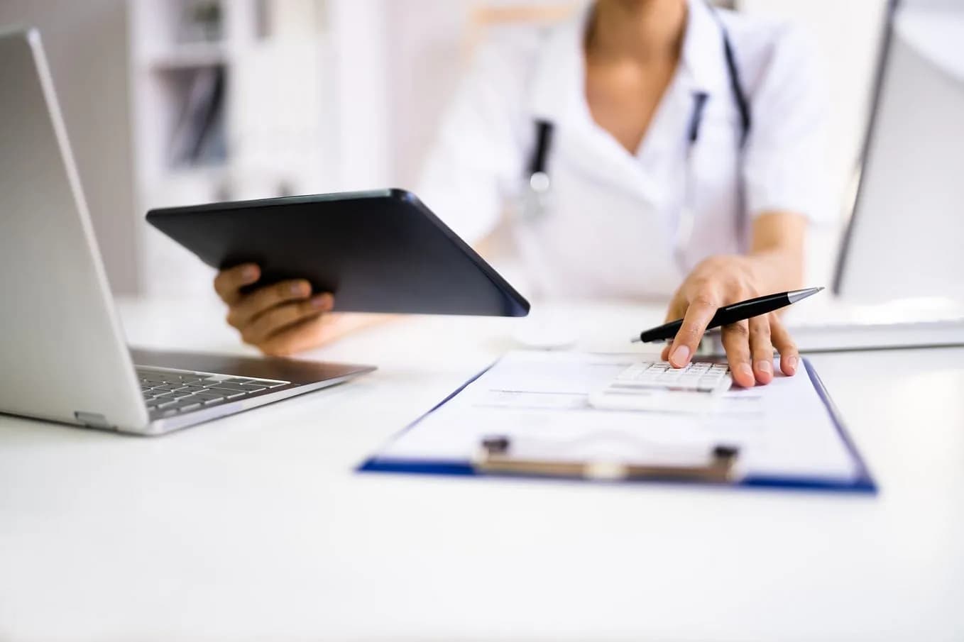 Clinician reviewing medical device documentation on a tablet