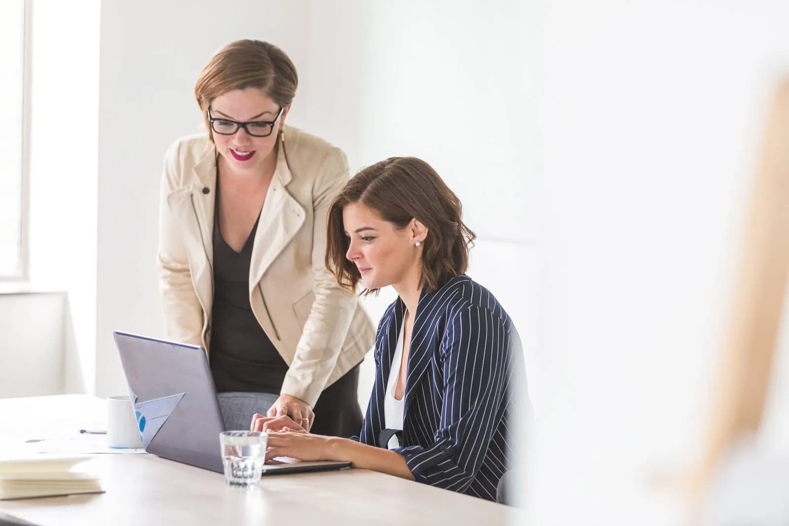 Two regulatory professionals reviewing compliance documents together