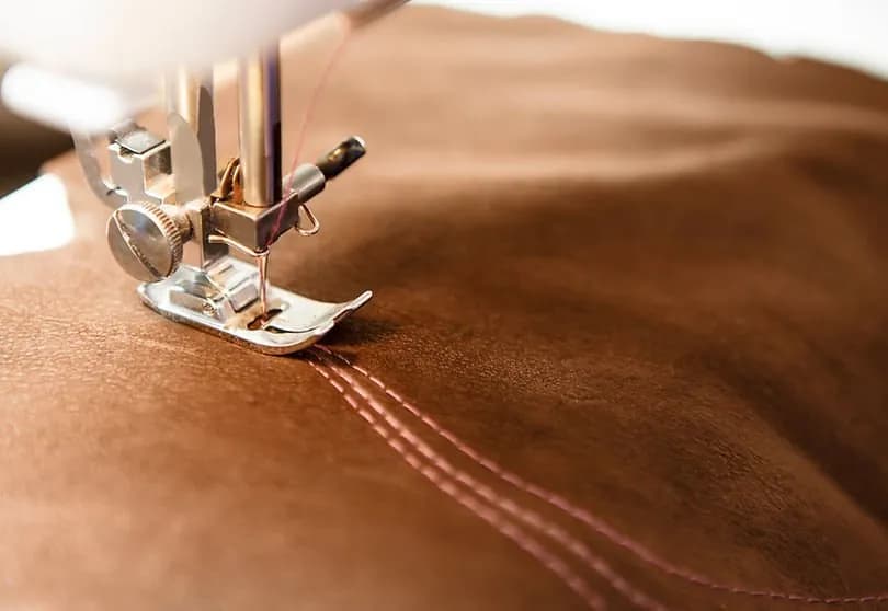 Precision stitching on protective material in body armor manufacturing