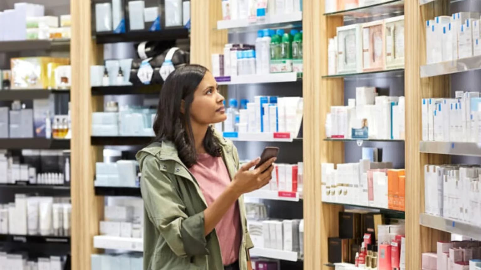 Customer browsing pharmacy and cosmetics shelves