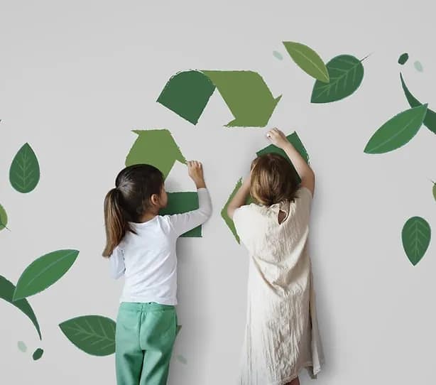 Children placing recycling symbols on a wall, representing environmental management